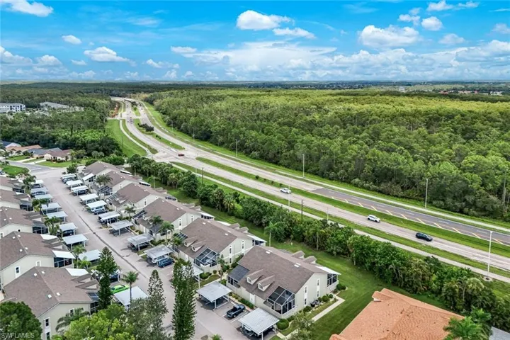 Aerial view of residential area featuring a heavily wooded area