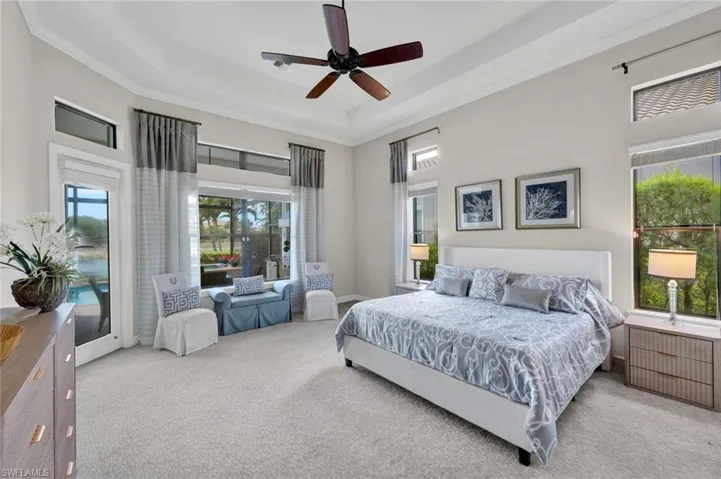 Primary Bedroom with a great reading and quiet relaxing area to unwind, door to lanai and double walk in closets with custom closets.