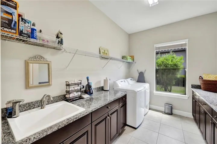 Private Laundry room with great counter space and storage, this is a private laundry room you can close the door you don't walk through this to get to the garage.