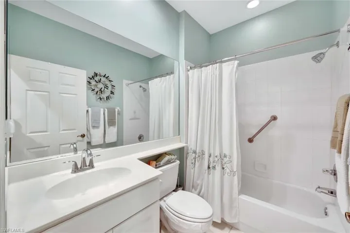 Full bathroom featuring shower / bath combo, toilet, and vanity