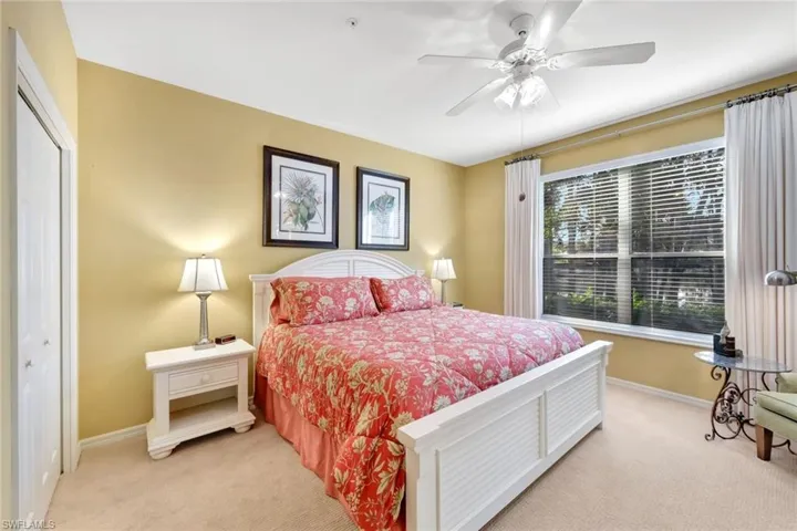 Carpeted bedroom featuring a closet and ceiling fan