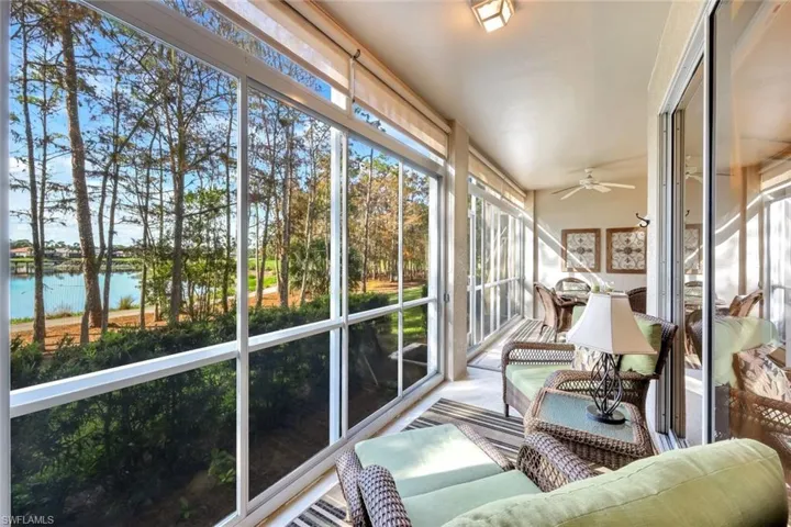 Sunroom / solarium with a wealth of natural light, ceiling fan, and a water view