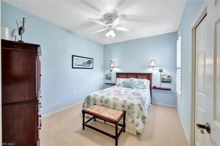 Carpeted bedroom featuring ceiling fan