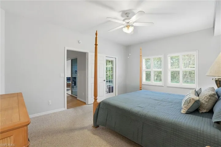 Bedroom with ceiling fan, carpet, and access to exterior