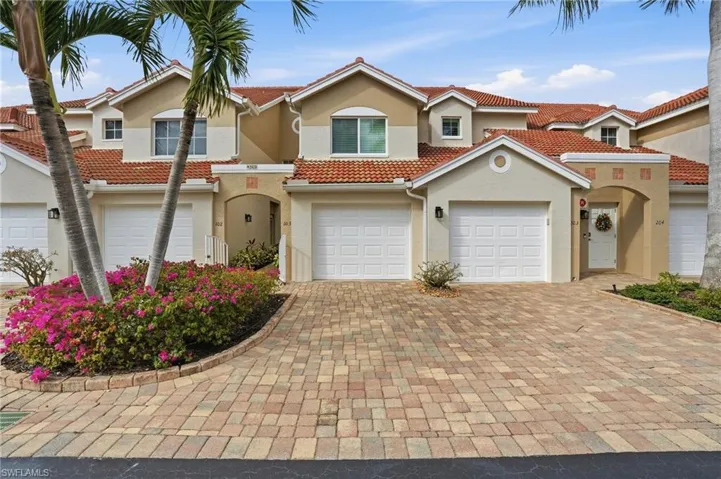 Mediterranean / spanish-style home with stucco siding, decorative driveway, a tiled roof, and an attached garage