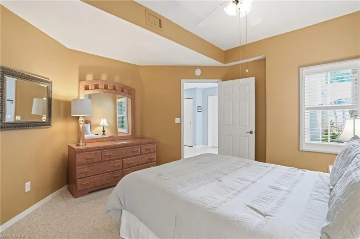 Carpeted bedroom featuring baseboards and a ceiling fan
