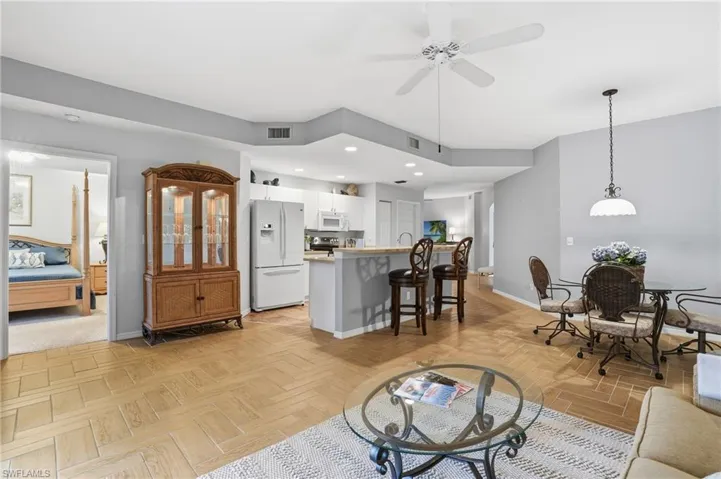 Living area with a ceiling fan and recessed lighting