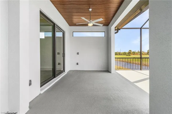Unfurnished sunroom featuring ceiling fan and wooden ceiling