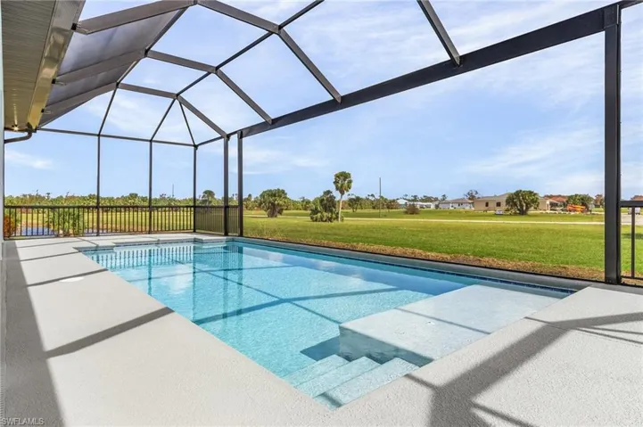 View of pool featuring a patio area, a lanai, and a yard