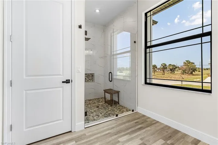 Bathroom featuring an enclosed shower and hardwood / wood-style flooring