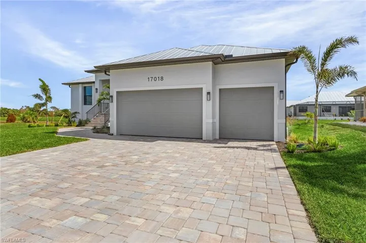 View of front of house featuring a front yard and a garage