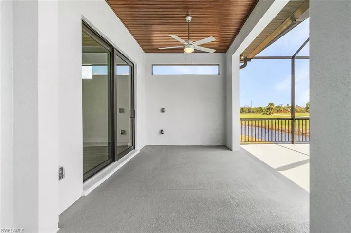 Unfurnished sunroom with a healthy amount of sunlight, wooden ceiling, and ceiling fan