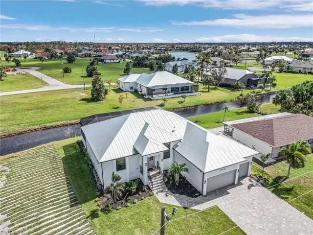 Birds eye view of property with a water view