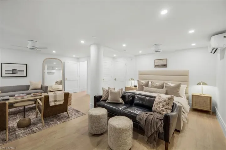 Bedroom featuring light wood finished floors, recessed lighting, and a wall unit AC