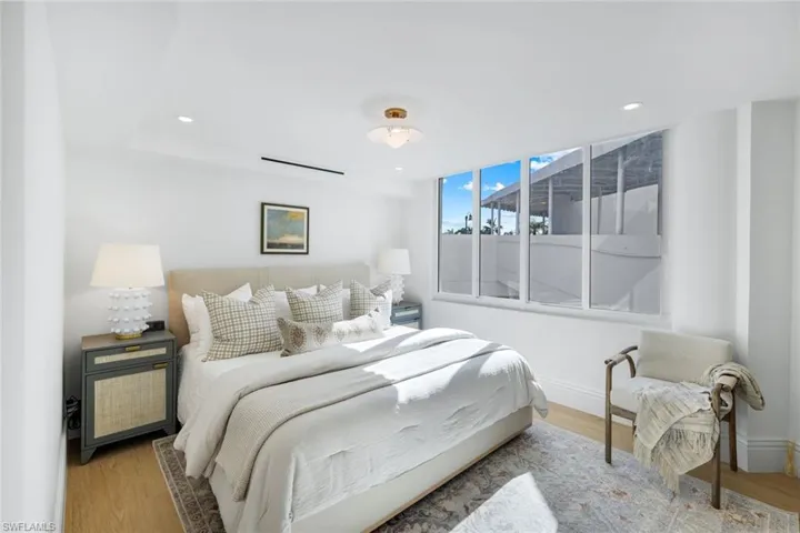 Bedroom with wood finished floors and recessed lighting