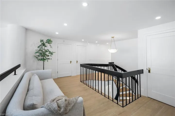 Stairway featuring recessed lighting and wood finished floors