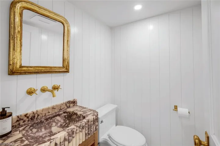 Half bathroom featuring vanity and recessed lighting