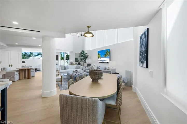 Dining room with light wood-type flooring and recessed lighting