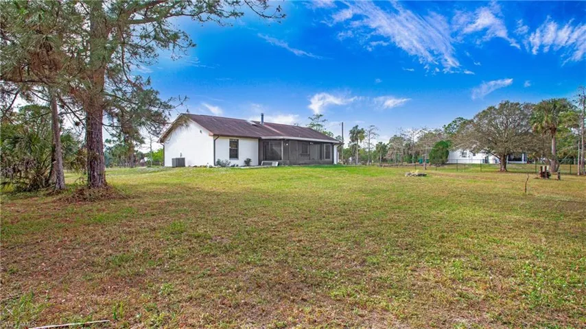 View of the rear featuring covered lanai and fire pit