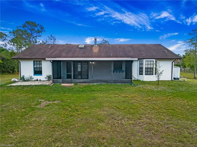 Rear view of property showing the covered lanai