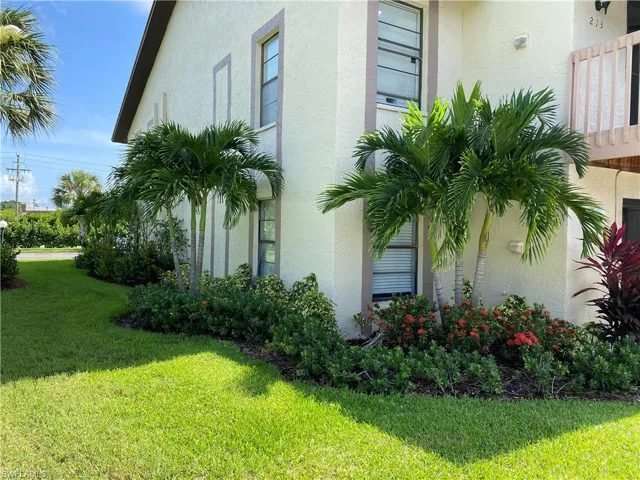 View of home's exterior with stucco siding and a yard