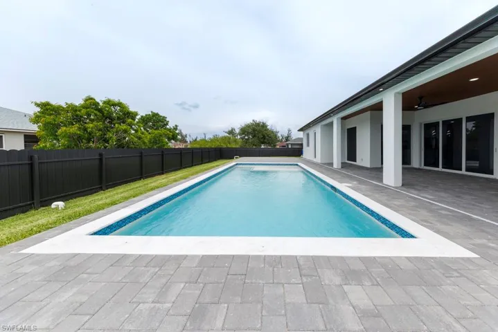 View of swimming pool with a patio, a ceiling fan, and a fenced backyard