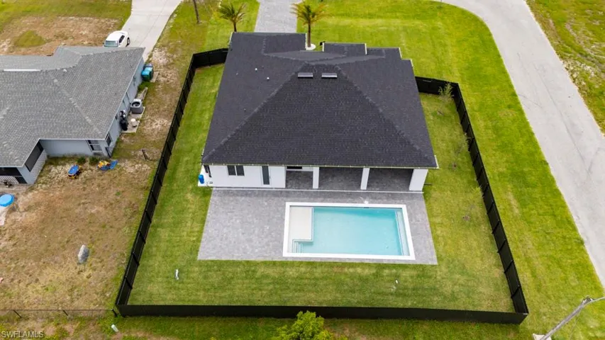 Aerial view of property and surrounding area featuring a pool area