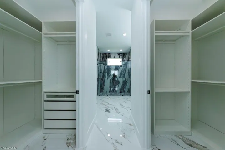 Walk in closet with marble tiled flooring