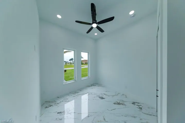 Unfurnished room with recessed lighting, marble tiled flooring, and ceiling fan
