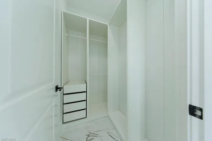 Spacious closet with marble finish flooring