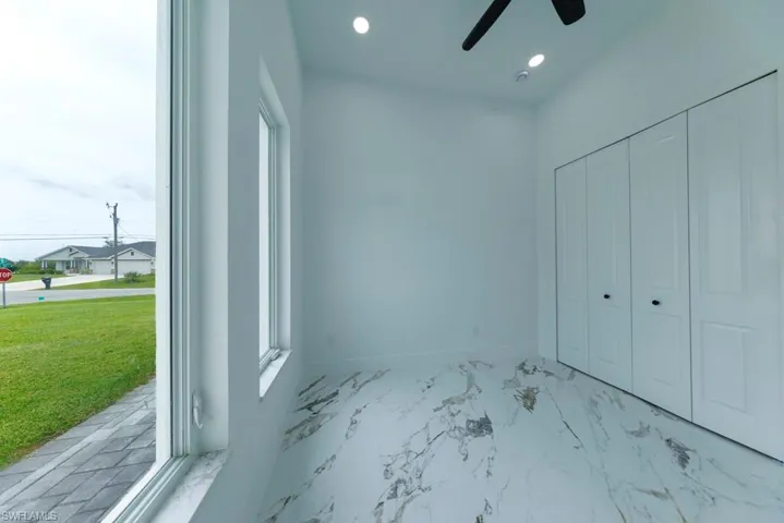Unfurnished bedroom with light marble finish floors, recessed lighting, a closet, and ceiling fan