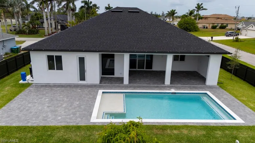 Back of property with a fenced backyard, a patio, stucco siding, a shingled roof, and a residential view