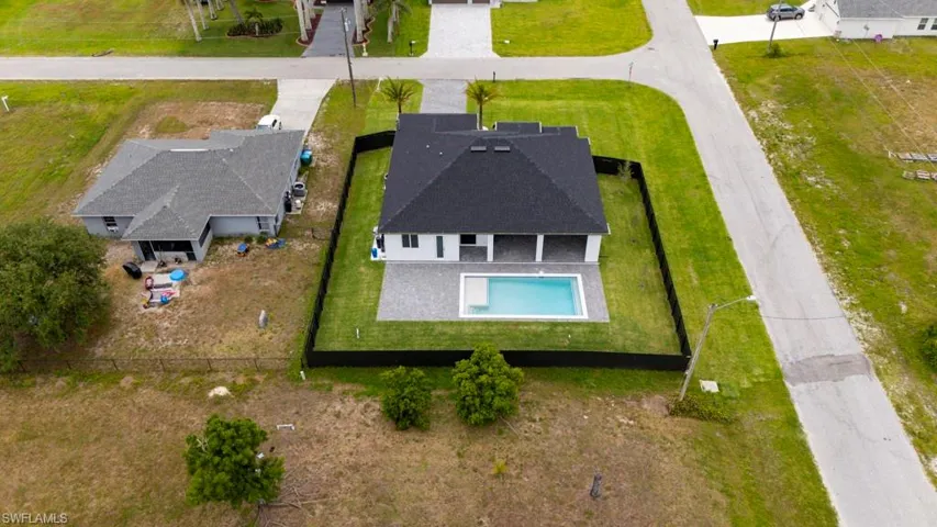 Aerial view of residential area featuring a pool area