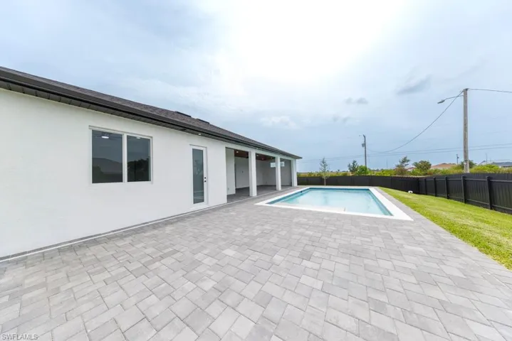 View of pool with a fenced backyard and a patio area