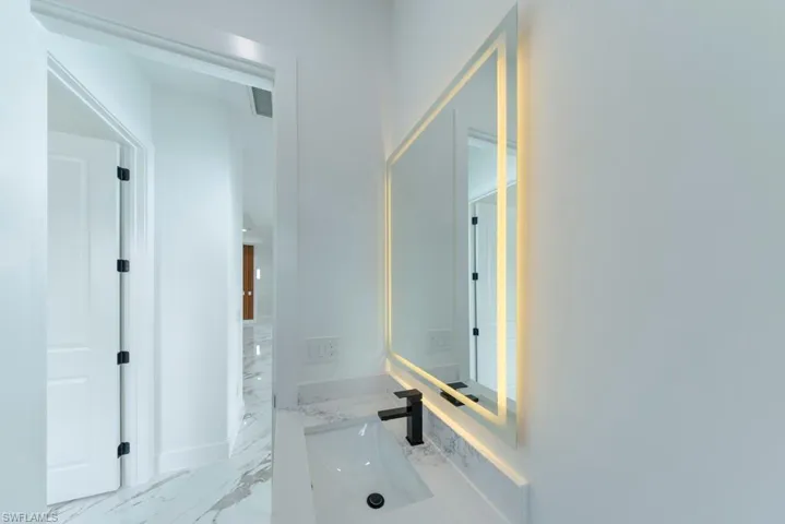 Bathroom with vanity and marble finish flooring