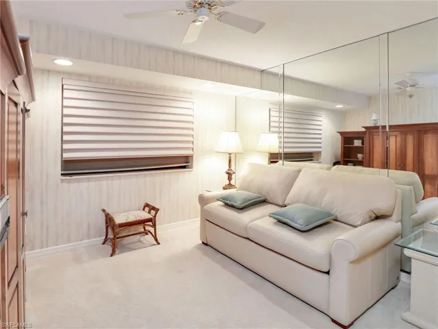 Living room featuring light colored carpet and ceiling fan