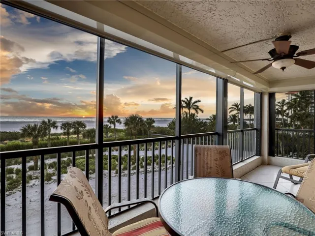 Sunroom / solarium featuring a water view and ceiling fan