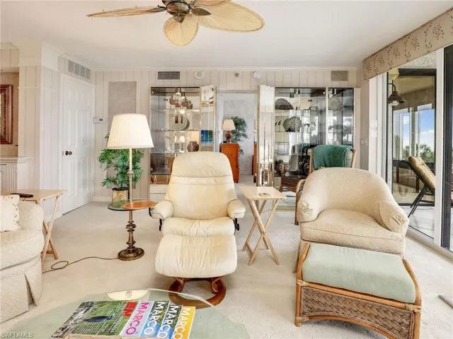 Living room featuring carpet flooring and ceiling fan