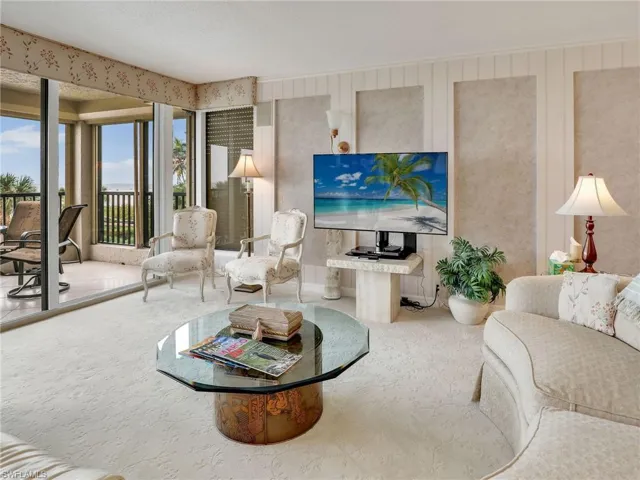 Carpeted living room featuring a healthy amount of sunlight