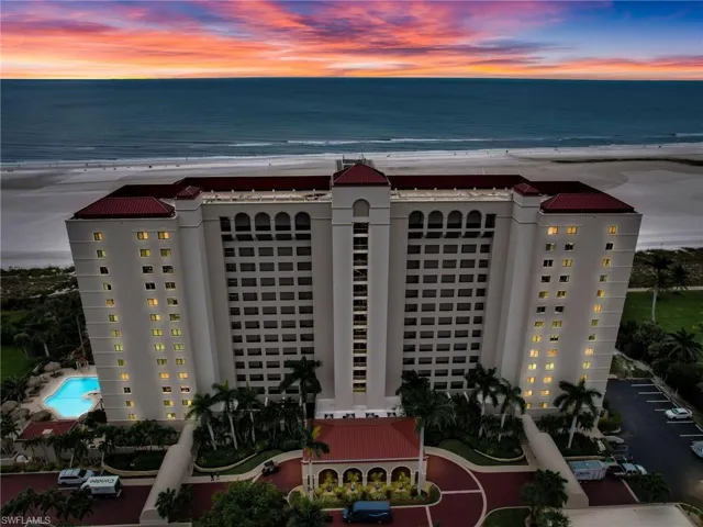Aerial view at dusk with a view of the beach and a water view