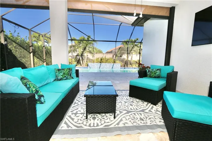 View of patio / terrace with an outdoor pool, outdoor lounge area, a sunroom, and glass enclosure