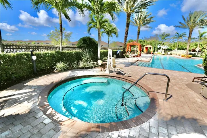 Community pool featuring a patio and a community hot tub