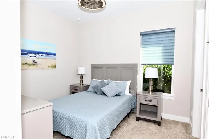 Bedroom featuring carpet floors and baseboards