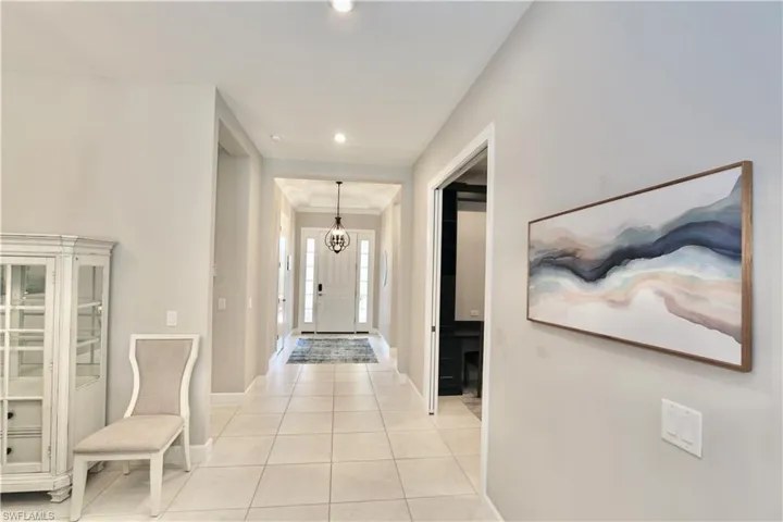 Foyer with light tile patterned floors and recessed lighting