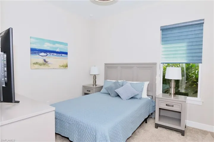 Bedroom with light carpet and baseboards