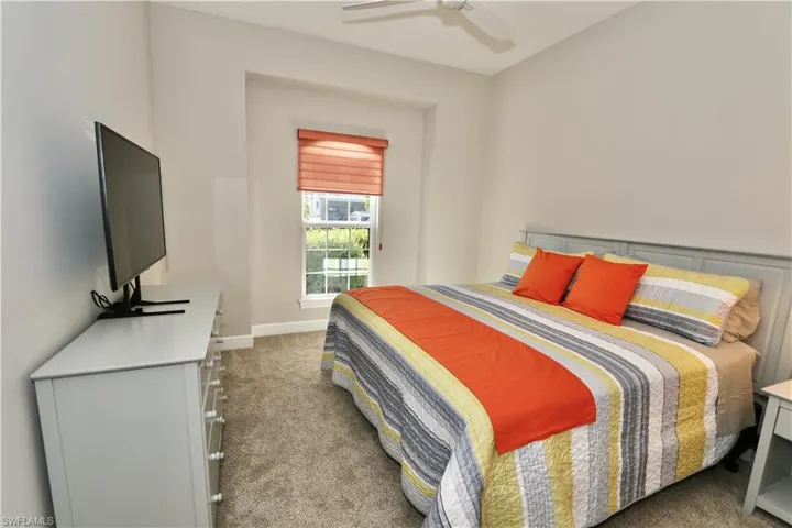 Bedroom featuring light carpet and ceiling fan