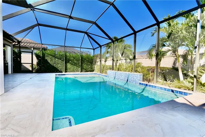 Outdoor pool featuring a sunroom, a patio, and a lanai