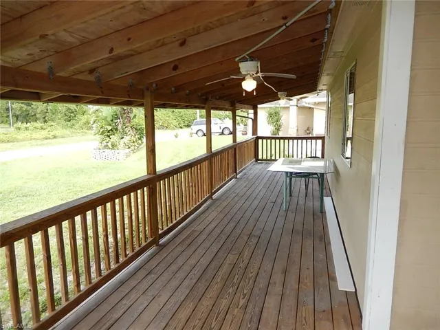 Deck with a ceiling fan and a yard
