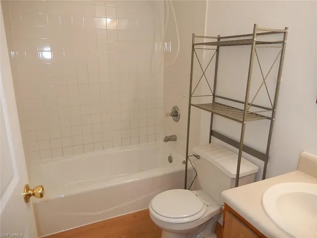 Full bathroom featuring shower / bath combination, vanity, and light wood-type flooring