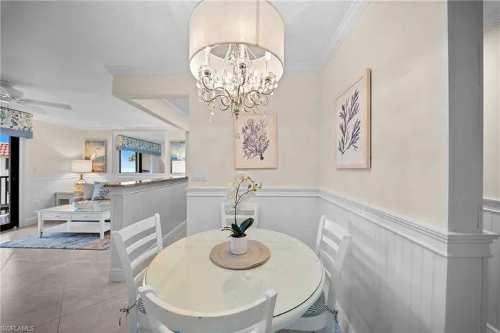 Dining area with wainscoting and a chandelier